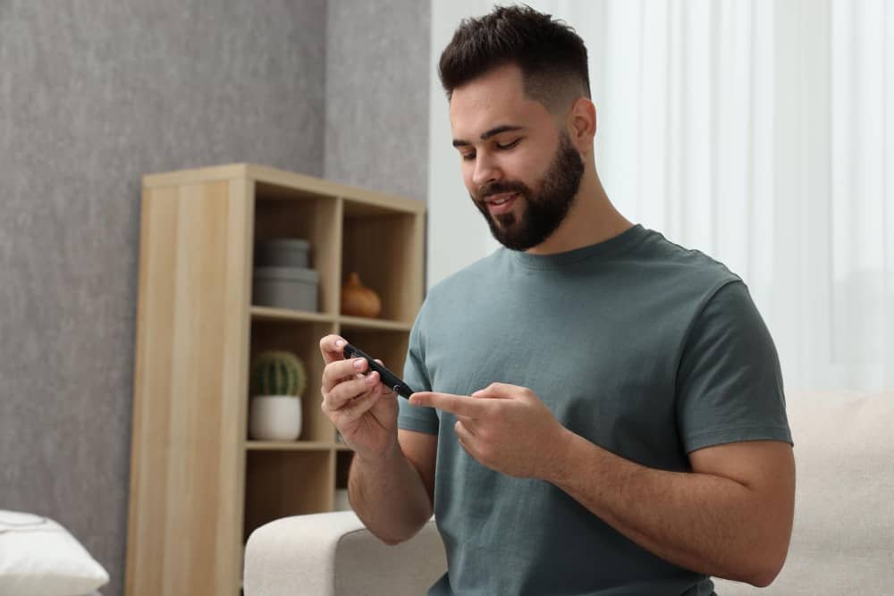 person checking blood sugar levels with glucometer
