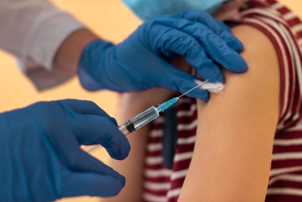 Child receiving MMR vaccine for measles protection