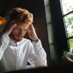 Person feeling mentally drained every day while working at a laptop
