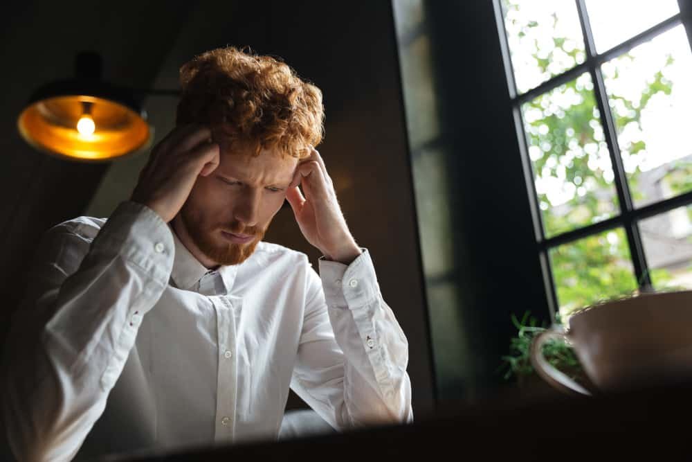 Person feeling mentally drained every day while working at a laptop